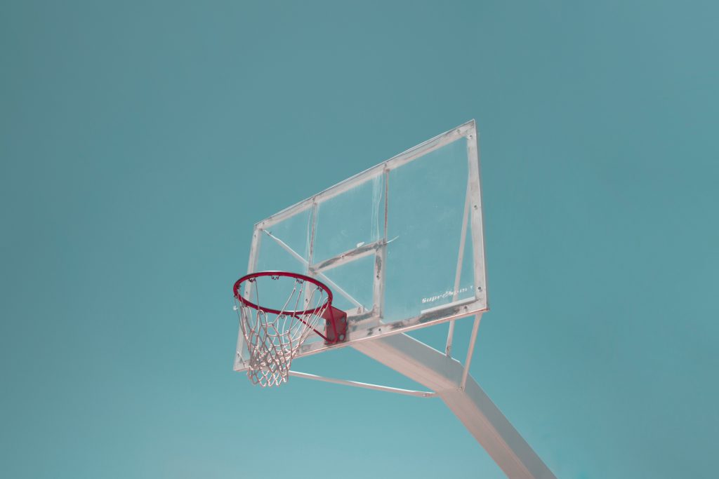 basketball hoop net glass backboard against turquoise blue sky retro filter