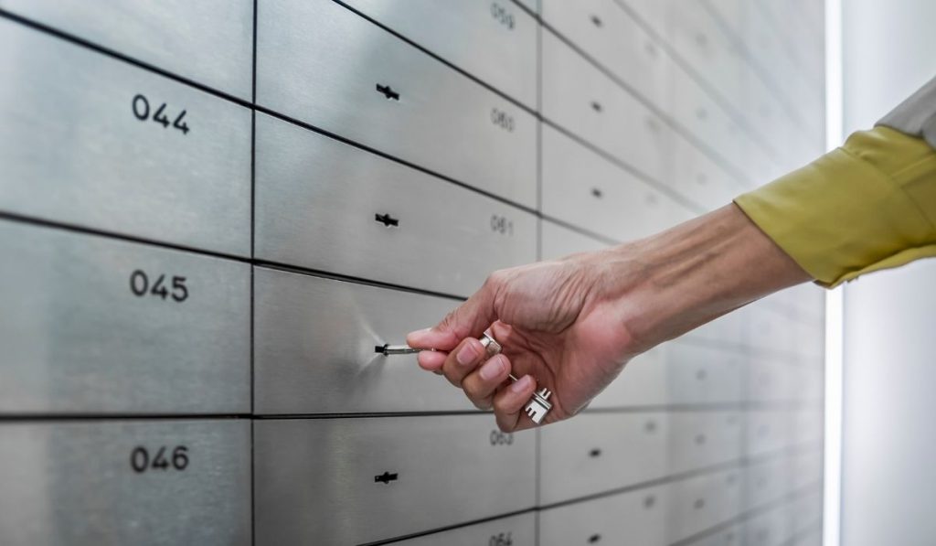 a man opening a safe deposit box