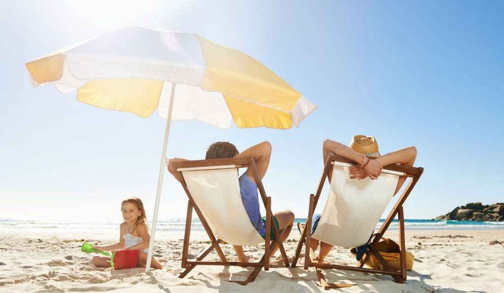 family relaxing at the beach