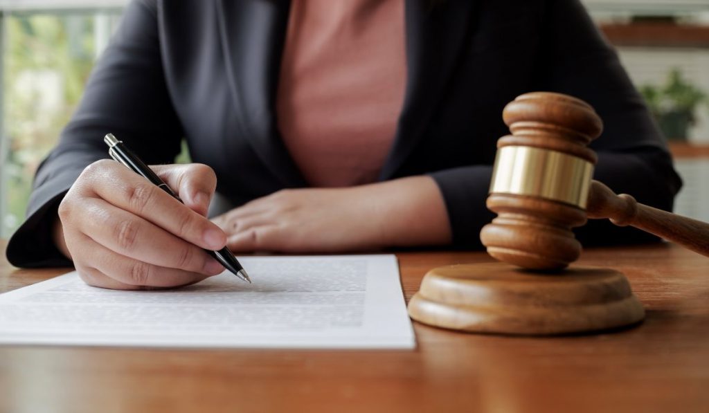 girl signing a document