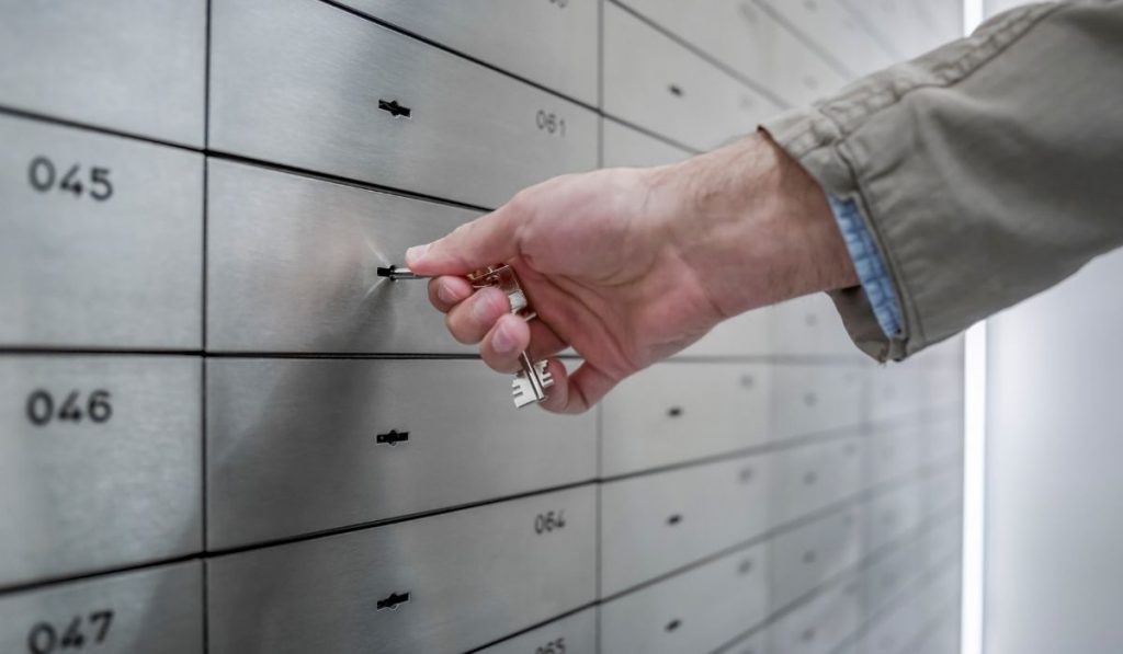 man opening a safe deposit box