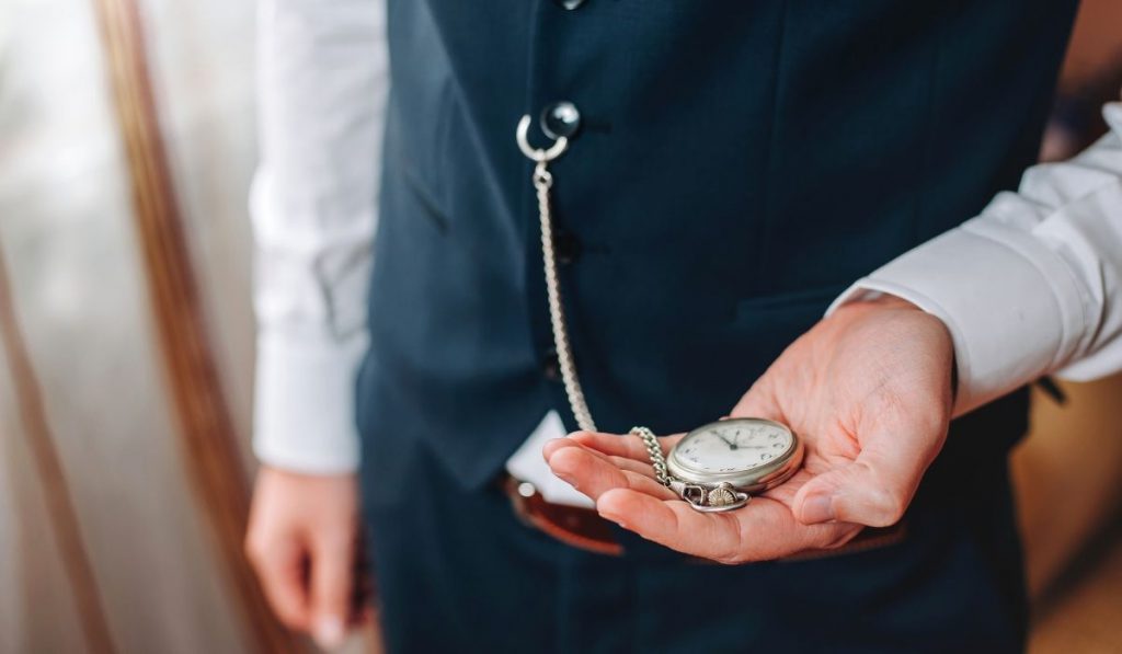 a man holiding a pocket watch.