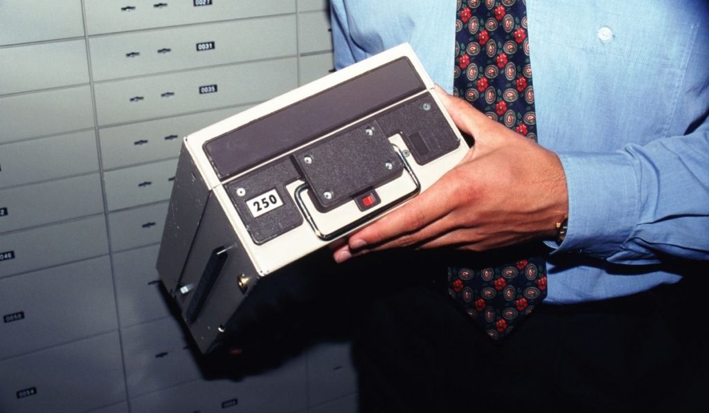 a man holding a safe deposit